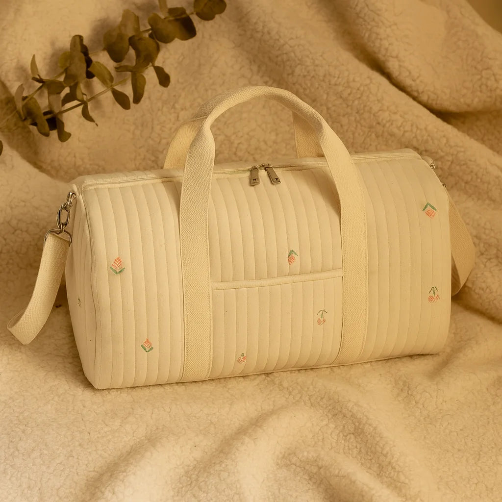 Sac à Langer Brodé Fleurs posé sur un plaid, broderies tulipes et cerises | BebeSac